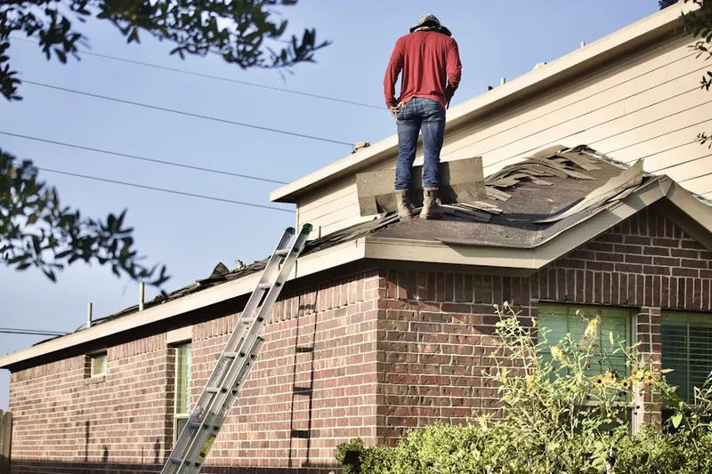 Professional roofer working on a residential roof in Gerton
